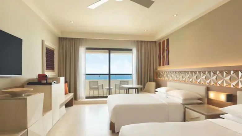 Club Oceanfront Double room with two double beds and private balcony overlooking the Caribbean Sea at Hyatt Ziva Cancun.