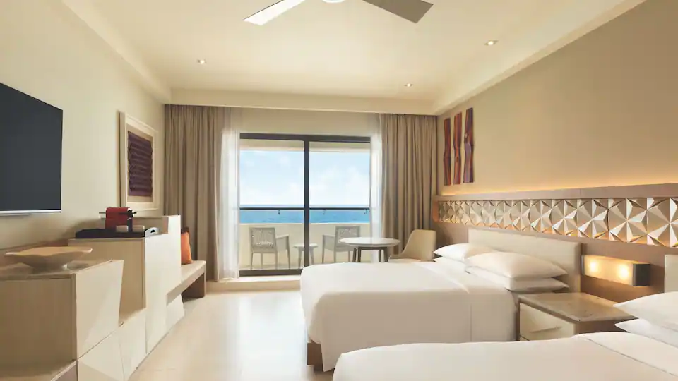 Club Oceanfront Double room with two double beds and private balcony overlooking the Caribbean Sea at Hyatt Ziva Cancun.