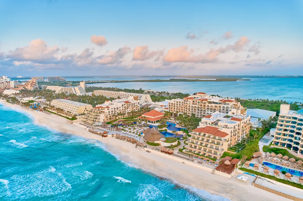 Fiesta Americana Condesa Cancun all-inclusive beachfront resort with tropical pool area, palapa bars, and white sand beach in Cancun Hotel Zone.
