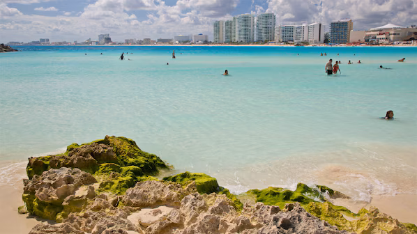 Gaviota Azul Beach near Hyatt Ziva Cancun featuring white-sand shores, turquoise Caribbean waters, and scenic beachfront views