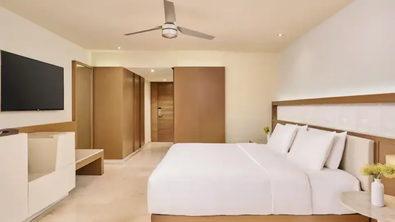 Oceanfront Lighthouse Suite bedroom with king bed, private balcony, and panoramic sea views at Hyatt Ziva Cancun.