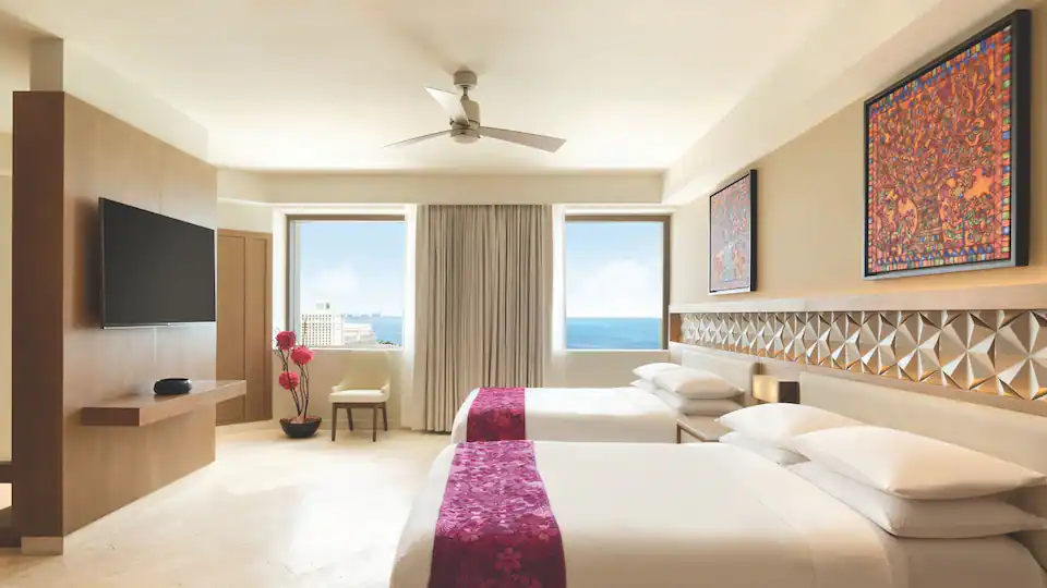 Presidential Suite bedroom with two queen beds and partial ocean views at Hyatt Ziva Cancun.