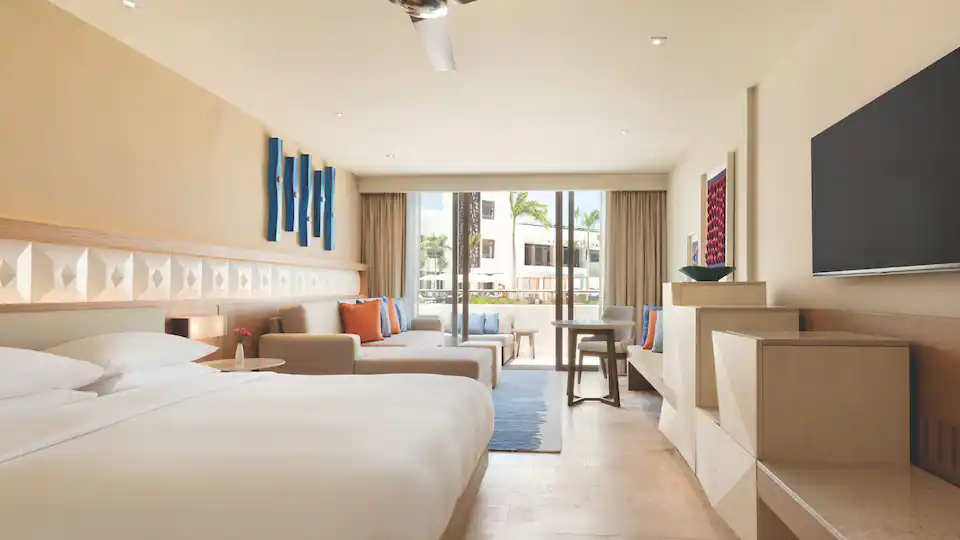 Resort View King room with sofa bed, modern furnishings, and private balcony overlooking the resort at Hyatt Ziva Cancun.