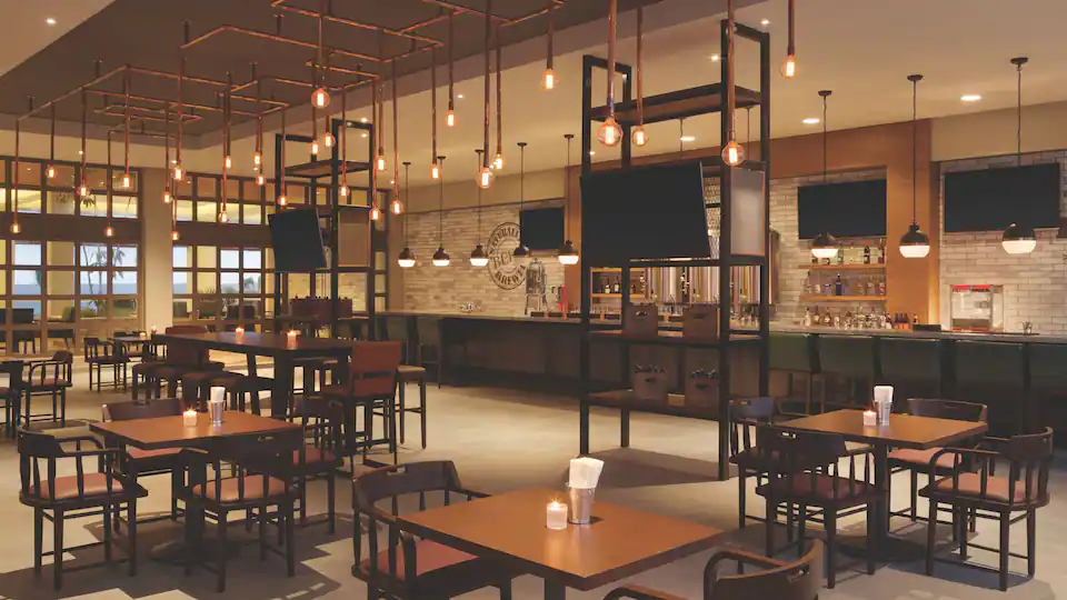 Tres Cervezas Brewery at Hyatt Ziva Cancun featuring craft beer taps, rustic brewery décor, and a relaxed gastropub atmosphere.