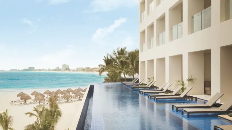 Turquoize Sky Swim-Up Oceanfront Master Double infinity pool overlooking the beach and Caribbean Sea at Hyatt Ziva Cancun.