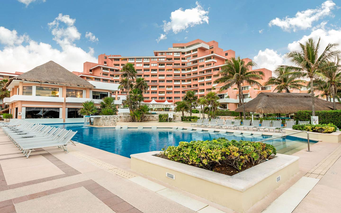 Wyndham Alltra Cancun all-inclusive resort with beachfront pools, palm trees, and family-friendly amenities in Cancun's Hotel Zone.